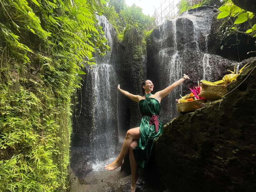 Bali: Purification Ritual at Taman Beji Griya - Taman Beji Griya purification: waterfall air, cave steps, and the sarong moment