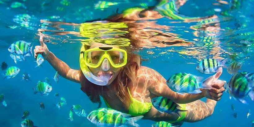 Bali: Snorkeling on 2 spots with Lunch and Transport - Stop 1 at Blue Lagoon Beach: colorful fish over coral reefs