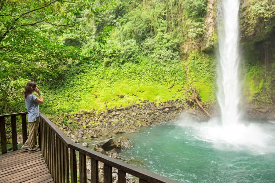 Bali Waterfall Tour with Lunch Views of Mount Batur - Kanto Lampo Waterfall: tiered rocks, cool mist, and shallow stream dipping