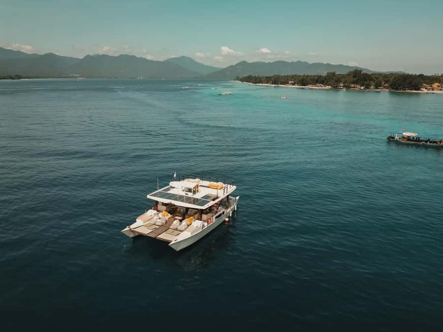 Gili Islands: 4-in-1 Catamaran Snorkeling Experience - Onboard play: paddleboards, beanbags, and roof-deck jumps